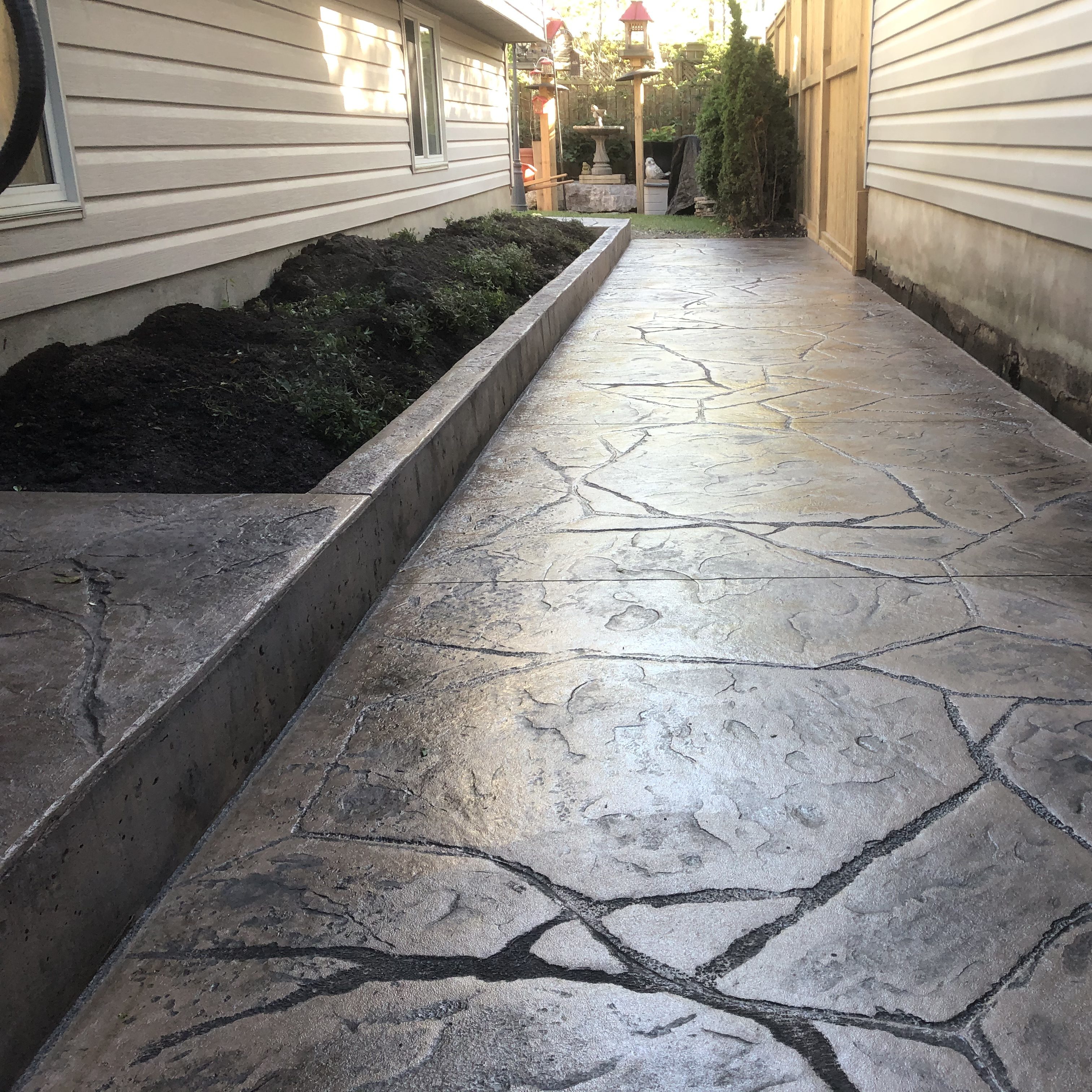Rough Cut Stone Stamped Concrete Curb in London Ontario